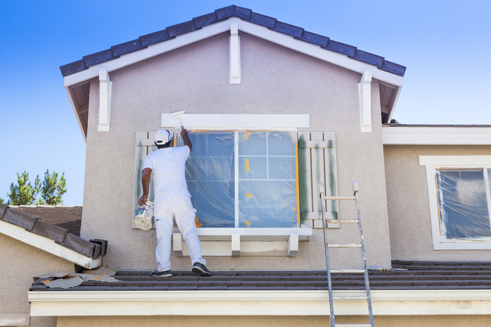 a painter painting a house